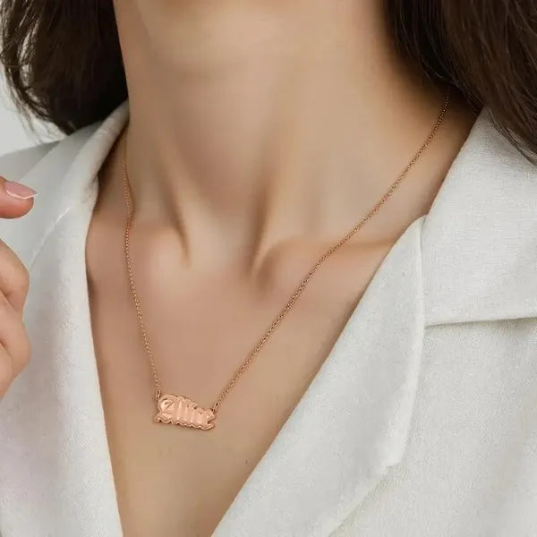 Rose gold Alice name necklace worn on model