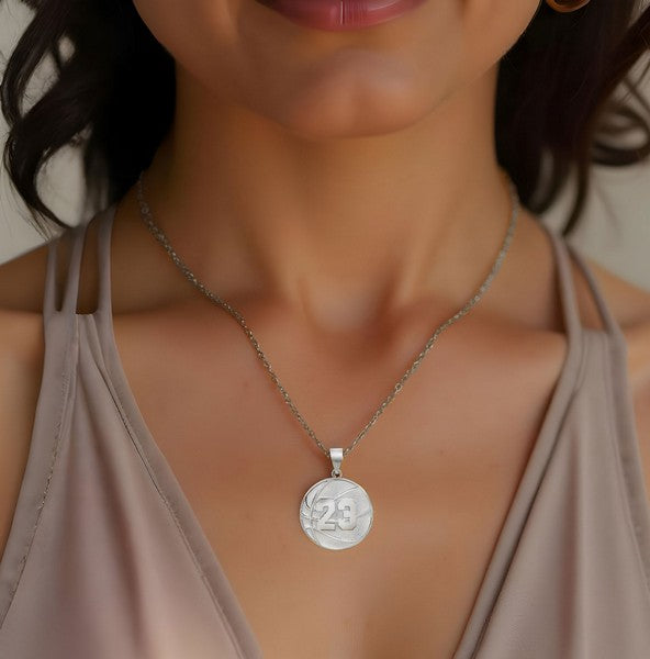 Basketball charm pendant worn by woman in sterling silver