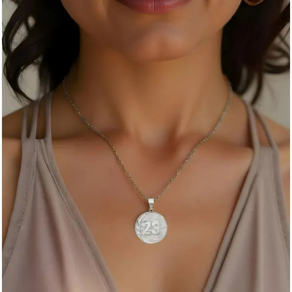 White gold basketball pendant worn by woman