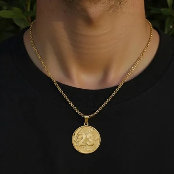 Basketball pendant worn by man in yellow gold