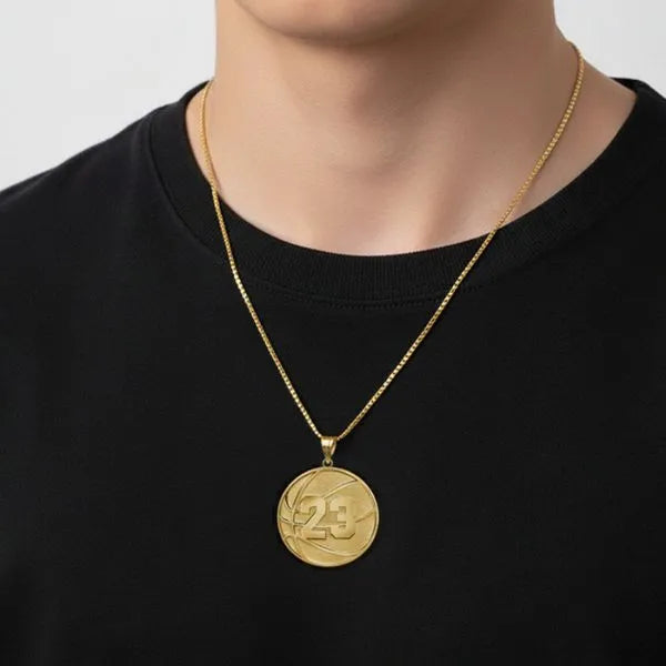 Basketball pendant worn by teen in yellow gold