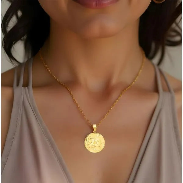 Basketball pendant worn by woman in yellow gold