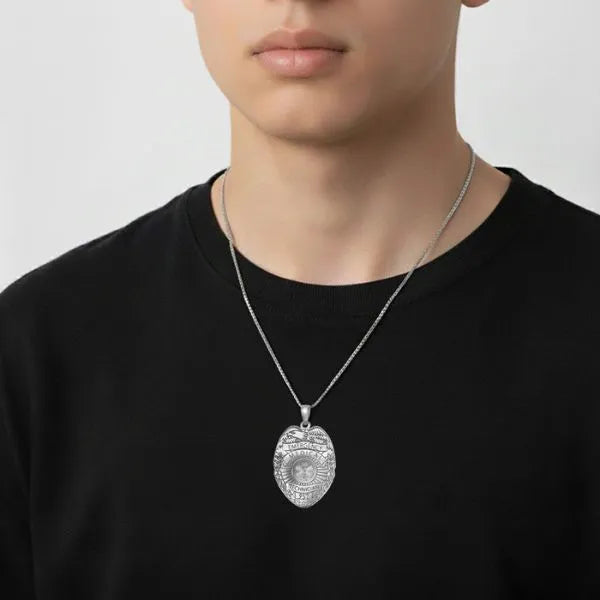 White gold EMT badge pendant worn by teen