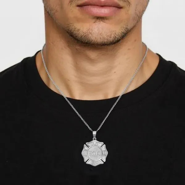 Firefighter badge charm pendant worn by man in sterling silver