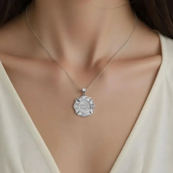Firefighter badge charm pendant worn by woman in sterling silver