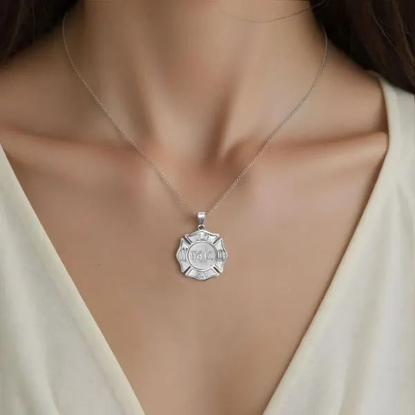 White gold firefighter badge pendant worn by woman