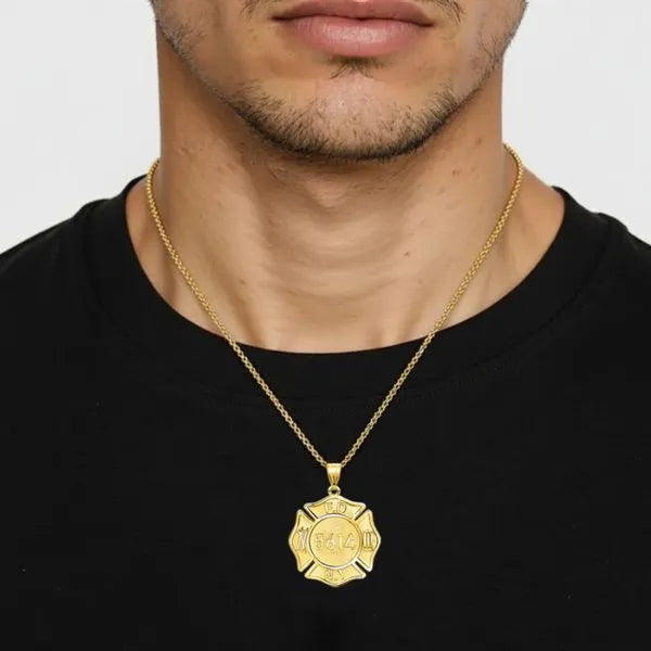 Firefighter badge pendant worn by man in yellow gold