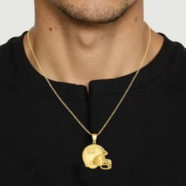 Football helmet pendant worn by man in yellow gold