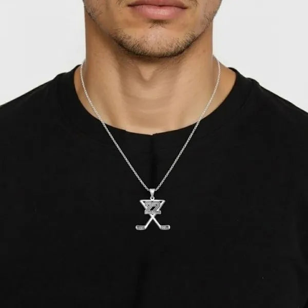 Hockey charm pendant worn by man in sterling silver