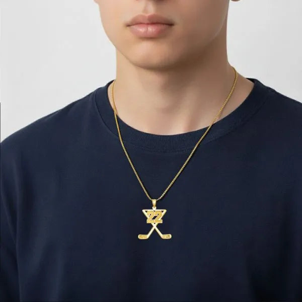 Hockey pendant worn by teen in yellow gold