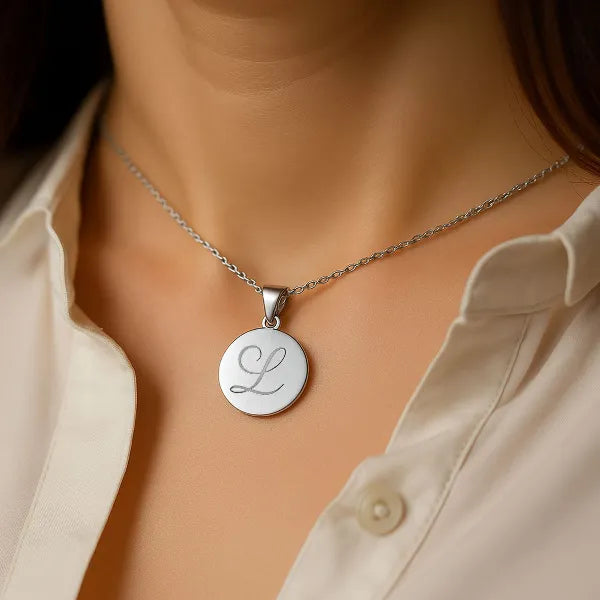 Initial disc pendant front view in white gold