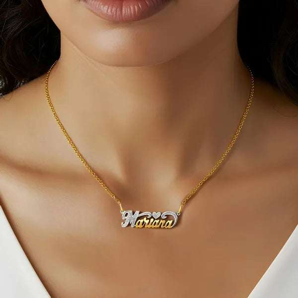 Model showcasing Marina heart name necklace in yellow gold