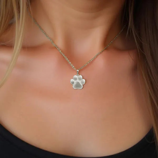 Paw print pendant worn in sterling silver