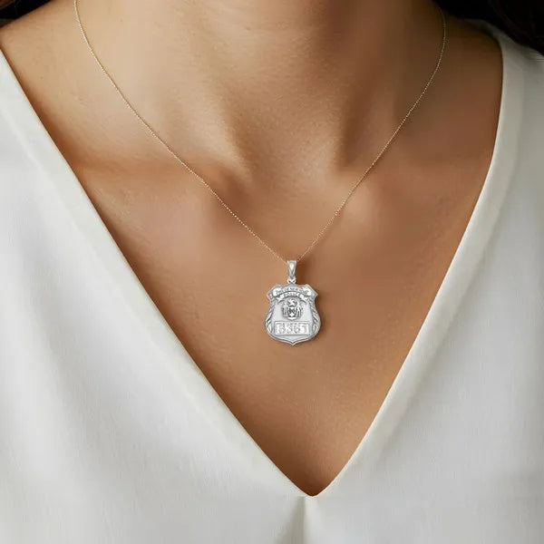 Police badge charm pendant worn by woman model in sterling silver