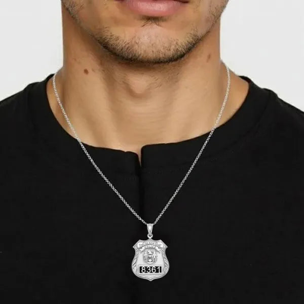 White gold police badge pendant worn by man