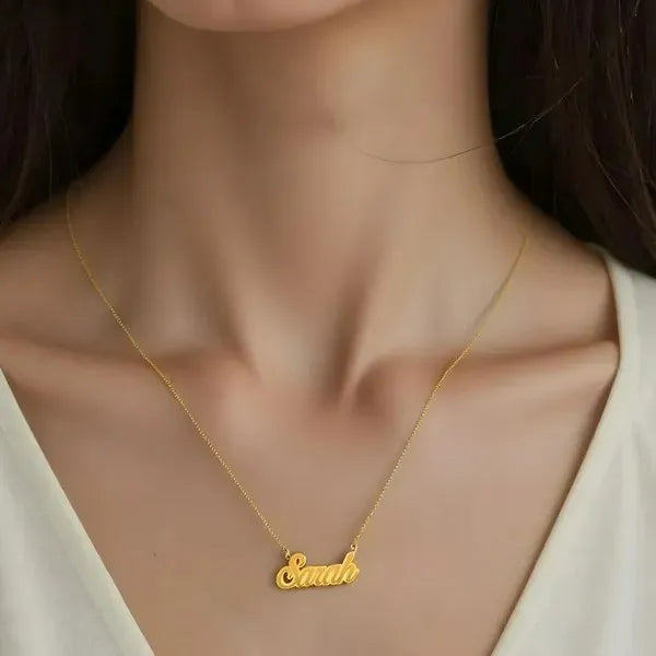 Model showcasing Sarah fancy name necklace yellow gold