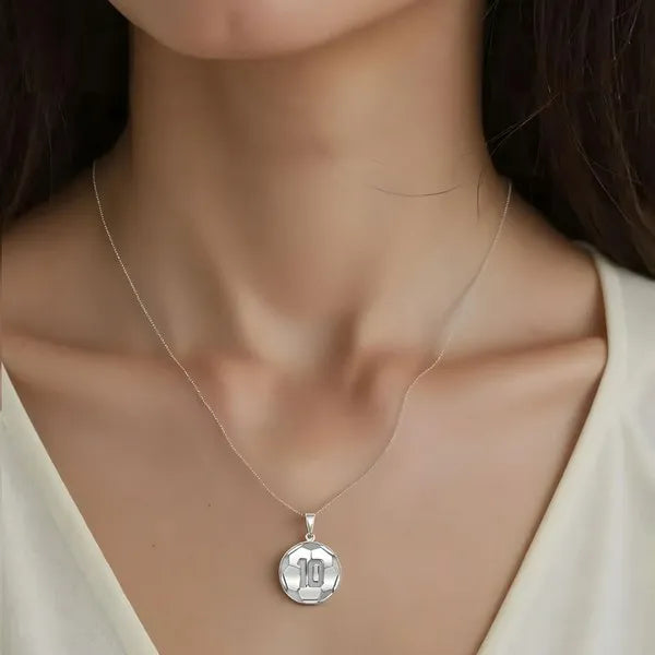 Soccer ball pendant worn by woman in sterling silver