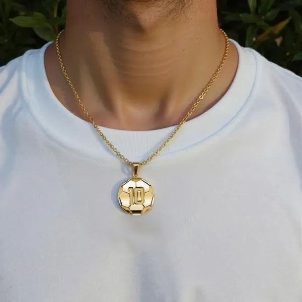 Soccer ball pendant worn by man in yellow gold