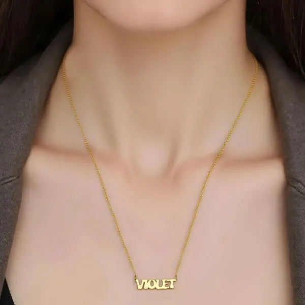 Model showcasing Violet retro letter name necklace yellow gold